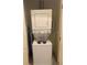 A compact laundry area features a stacked washer and dryer unit at 3026 Bella Vista Dr, Davenport, FL 33897