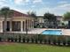 View of a community pool and clubhouse with tables and chairs at 3026 Bella Vista Dr, Davenport, FL 33897