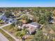 A serene aerial shot displays the home's screened pool and palm-lined yard within its residential community at 3252 Noah St, Deltona, FL 32738