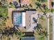 Birds eye view of a house with a pool, patio, driveway, and mature landscaping at 3252 Noah St, Deltona, FL 32738