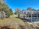 The yard has a pool with a screen enclosure, mature trees, and a privacy fence at 3252 Noah St, Deltona, FL 32738