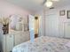 Bedroom featuring an ensuite bathroom, mirrored dresser, and hardwood floors at 3252 Noah St, Deltona, FL 32738