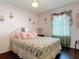 Cozy bedroom with floral bedding, dresser with mirror, and soft natural light at 3252 Noah St, Deltona, FL 32738