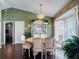 Comfortable dining space featuring wood flooring, a decorative chandelier, and a large china cabinet at 3252 Noah St, Deltona, FL 32738