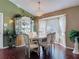 Charming dining room featuring a decorative chandelier, bay windows, and a built-in china cabinet at 3252 Noah St, Deltona, FL 32738