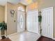 Elegant foyer with tile flooring, high ceilings, and a decorative front door at 3252 Noah St, Deltona, FL 32738