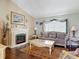 Comfortable living room with decorative fireplace, plush sofa, and area rug at 3252 Noah St, Deltona, FL 32738