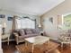 Cozy living room includes a plush sofa, stylish decor, and well-lit window at 3252 Noah St, Deltona, FL 32738