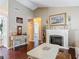 Living room featuring dark wood floors, fireplace, and view into other rooms at 3252 Noah St, Deltona, FL 32738