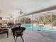 Covered and screened-in pool area with lounge chairs and lush landscaping in the backyard at 3252 Noah St, Deltona, FL 32738