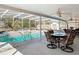 Outdoor screened-in pool with a hot tub and seating area at 3252 Noah St, Deltona, FL 32738