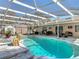 Screened-in pool with lush landscaping and seating areas at 3252 Noah St, Deltona, FL 32738