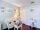 Charming sitting area with wicker sofa, glass coffee table and hardwood floors at 3252 Noah St, Deltona, FL 32738