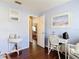 Cozy sitting area with hardwood floors, white wicker furniture, and natural light from the window at 3252 Noah St, Deltona, FL 32738