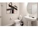Half bathroom with a decorative mirror, modern vanity, and a neutral color scheme at 3428 Lilac Way, Davenport, FL 33897