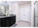 Bathroom featuring dual sinks with granite countertops and a separate shower space at 3428 Lilac Way, Davenport, FL 33897