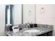 Bathroom features a granite countertop and stylish fixtures, providing a luxurious feel at 3428 Lilac Way, Davenport, FL 33897