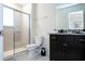 Well-lit bathroom featuring a dark vanity with granite countertop, a toilet, and a glass-enclosed shower at 3428 Lilac Way, Davenport, FL 33897