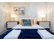 Comfortable bedroom with white bed, blue accents, stylish nightstands, and modern decor for relaxation at 3428 Lilac Way, Davenport, FL 33897