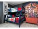 Vibrant ' bedroom featuring themed bunk beds, a colorful accent wall, and fun decor at 3428 Lilac Way, Davenport, FL 33897