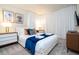 Comfortable bedroom with white bed, blue accents, stylish nightstands, and modern decor for relaxation at 3428 Lilac Way, Davenport, FL 33897