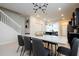 Elegant dining area featuring a modern table, contemporary lighting, and seamless access to the kitchen and living spaces at 3428 Lilac Way, Davenport, FL 33897