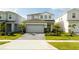 Charming two-story home featuring a well-manicured lawn and a paved driveway leading to an attached two-car garage at 3428 Lilac Way, Davenport, FL 33897
