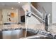 Close-up of a modern kitchen sink with granite countertop showcasing elegant design at 3428 Lilac Way, Davenport, FL 33897