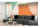 Stylish living room featuring a comfortable gray sectional sofa, decorative wall accents and modern glass coffee table at 3428 Lilac Way, Davenport, FL 33897