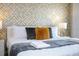Bright main bedroom features a king bed with stylish throw pillows and elegant side tables at 3428 Lilac Way, Davenport, FL 33897