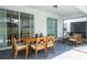 Covered patio featuring dining and lounge seating, with a glimpse of the pool at 3428 Lilac Way, Davenport, FL 33897
