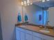 Bathroom featuring a double sink vanity, framed mirror, and soft lighting at 3593 Brighton Park Cir, Belle Isle, FL 32812