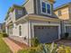 Lovely townhome with an attached garage, stone accents, and manicured landscaping at 3593 Brighton Park Cir, Belle Isle, FL 32812