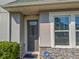 Inviting front entrance with a secure door, stone accents, and maintained shrubbery at 3593 Brighton Park Cir, Belle Isle, FL 32812