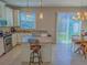 Well-equipped kitchen featuring granite counters, stainless appliances, and a center island next to a dining area at 3593 Brighton Park Cir, Belle Isle, FL 32812