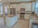 Bright kitchen featuring white cabinets, granite countertops, stainless steel appliances, and tile floors at 3593 Brighton Park Cir, Belle Isle, FL 32812
