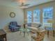 Comfortable living room featuring tile floors, neutral paint, and lots of natural light from multiple windows at 3593 Brighton Park Cir, Belle Isle, FL 32812