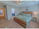 Comfortable main bedroom boasts a wooden bed frame, a ceiling fan, and a closet at 3593 Brighton Park Cir, Belle Isle, FL 32812