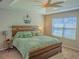 Cozy main bedroom featuring plush carpet, neutral paint, a decorative ceiling fan, and a large window at 3593 Brighton Park Cir, Belle Isle, FL 32812