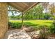 Covered back porch overlooking a well-maintained lawn and community tennis courts at 409 Oak Haven Dr # 409, Altamonte Springs, FL 32701