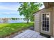 A patio with white tile floors looks out onto a picturesque lake and green lawn, perfect for enjoying the outdoors at 409 Oak Haven Dr # 409, Altamonte Springs, FL 32701