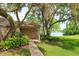 Serene backyard featuring lush lawn, mature trees, and a glimpse of the lake at 409 Oak Haven Dr # 409, Altamonte Springs, FL 32701