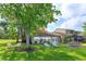 Spacious backyard with a well-manicured lawn, mature trees, and outdoor seating at 409 Oak Haven Dr # 409, Altamonte Springs, FL 32701