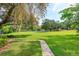 Lush backyard leading to community amenities, including tennis courts and green space at 409 Oak Haven Dr # 409, Altamonte Springs, FL 32701