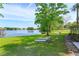 Expansive backyard with mature tree, lakeside view, and lounge chairs, ideal for relaxation and outdoor enjoyment at 409 Oak Haven Dr # 409, Altamonte Springs, FL 32701