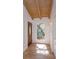 Bright entryway with wood-look tile flooring, beamed ceiling, and large window bringing in natural light at 409 Oak Haven Dr # 409, Altamonte Springs, FL 32701