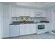 Bright kitchen featuring a stainless steel sink and appliances with white cabinets and granite countertops at 409 Oak Haven Dr # 409, Altamonte Springs, FL 32701