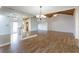 Open-concept living area with vaulted ceilings, wood floors, and a modern chandelier at 409 Oak Haven Dr # 409, Altamonte Springs, FL 32701