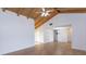 Bright living room showcasing the vaulted ceiling and wood-look tile flooring that flows into the dining area at 409 Oak Haven Dr # 409, Altamonte Springs, FL 32701