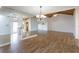 Open-concept living room with wood-look tile flooring, vaulted ceilings, and access to kitchen at 409 Oak Haven Dr # 409, Altamonte Springs, FL 32701